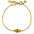 Bracelet doré et oeil martelé et pierre