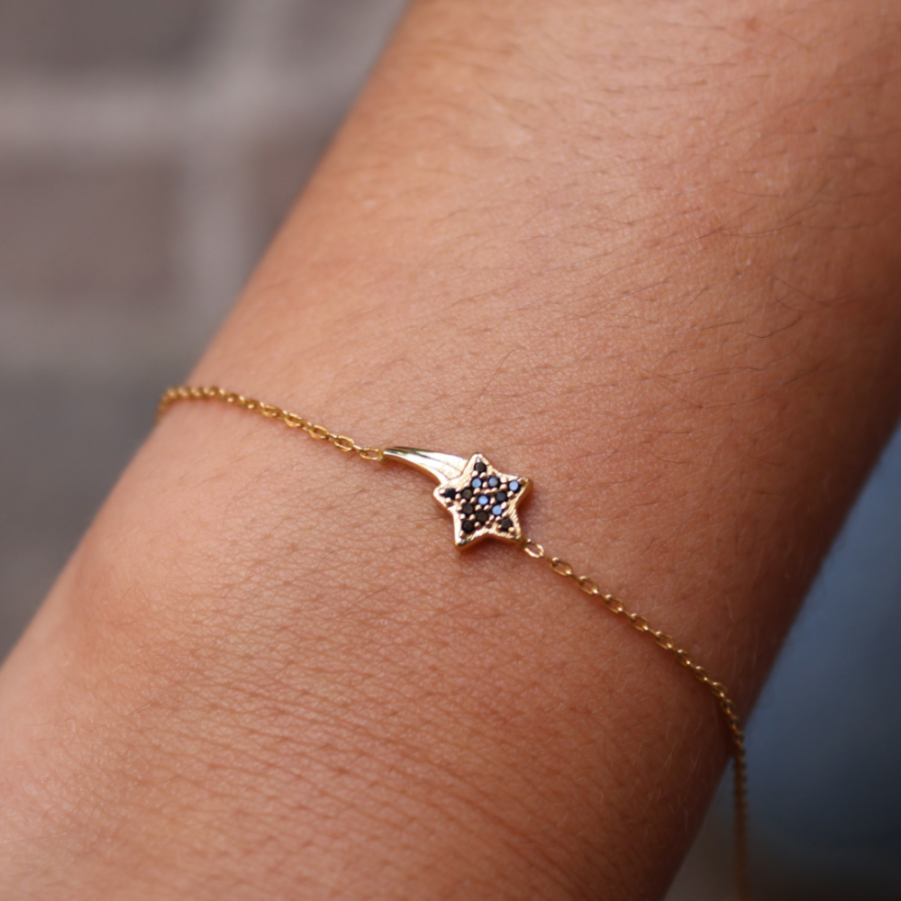Bracelet doré étoile filante avec zircons noirs